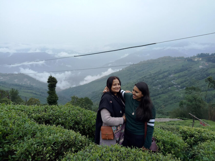 My mum and I in a Darjeeling tea plantation, feeling very fulfilled after drinking Darjeeling tea 