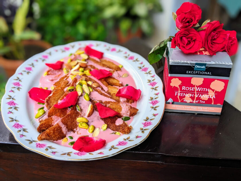 Dilmah's Rose With French Vanilla Tea next to the tea infused creamy dessert shahi tukra