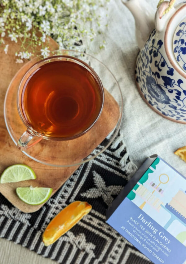 A cup of Whittard Darling Grey next to a box of Whittard Darling Grey teabags