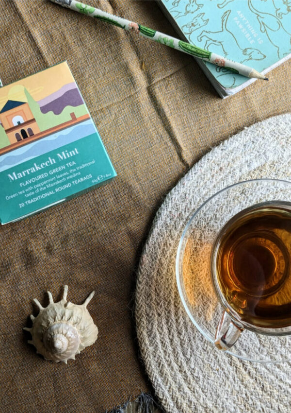 Marrakech Mint Green tea box next to cup of brewed tea
